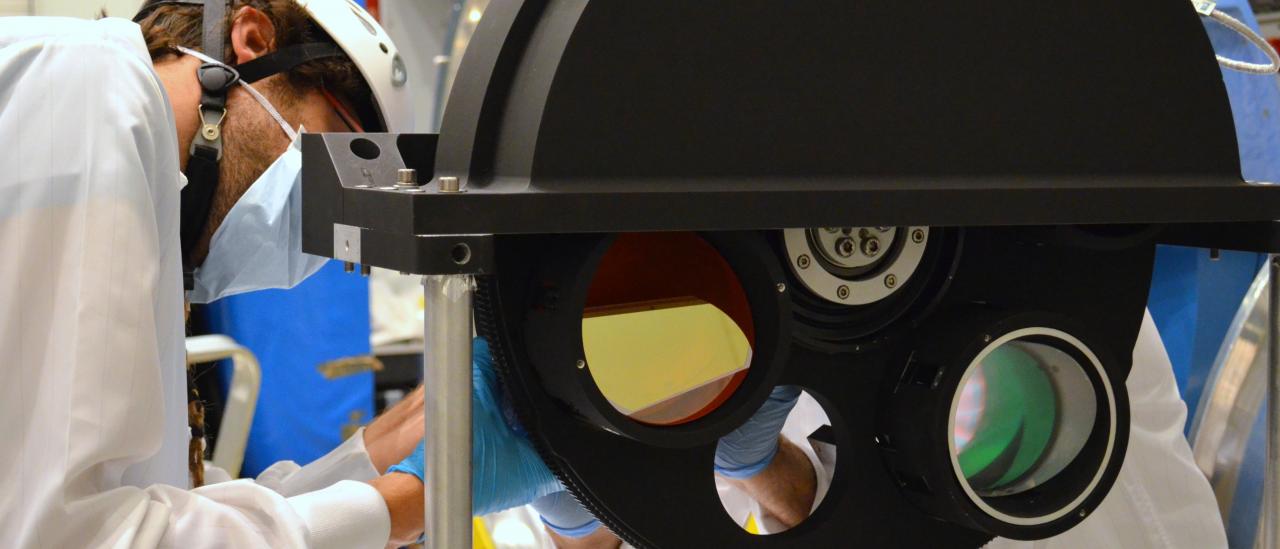 View of an engineer working on the grism wheel of EMIR at the laboratory