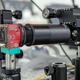 Laboratory optical setup showing the small multimode fibre encapsulated inside a white ferrule and used to experimentally verify the sensor’s behaviour.